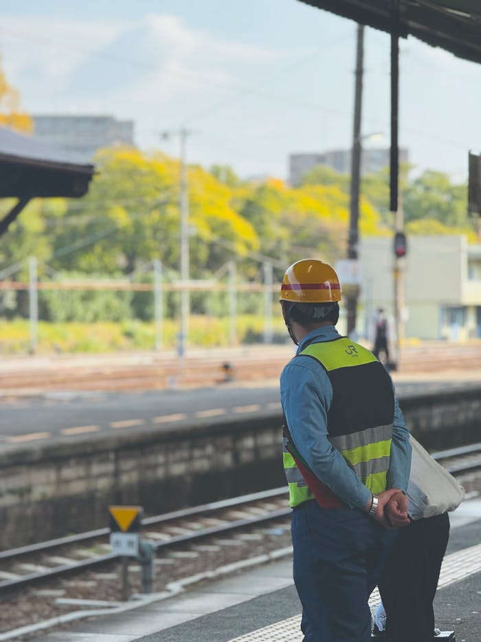 services-01 Engineer in safety gear observing railway tracks at Tokushima train station, Japan.